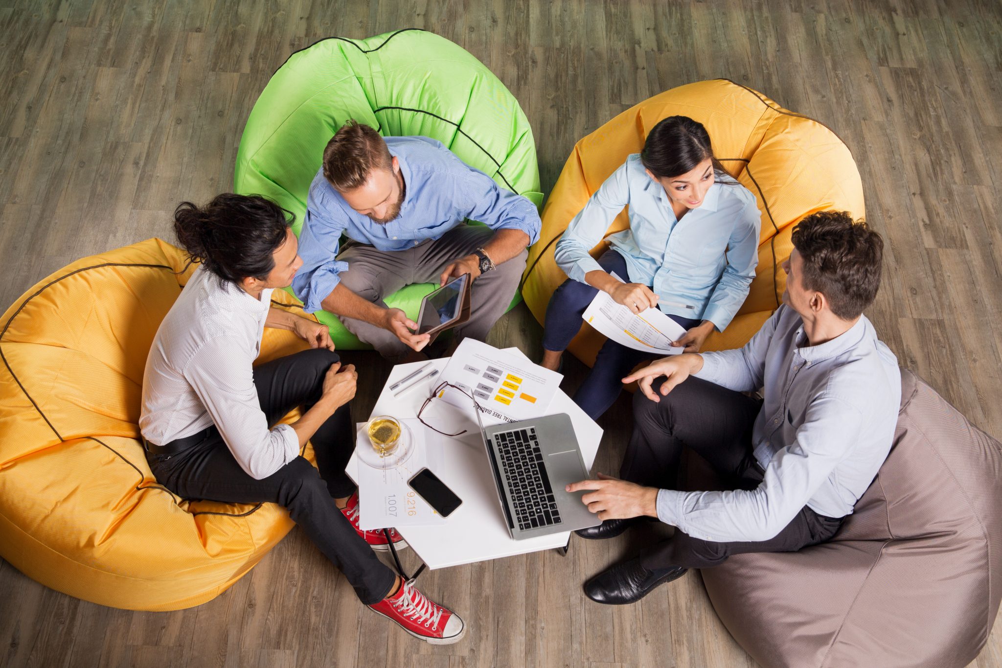 four people sitting on bean bags