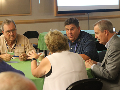 Four people having a discussion at a table